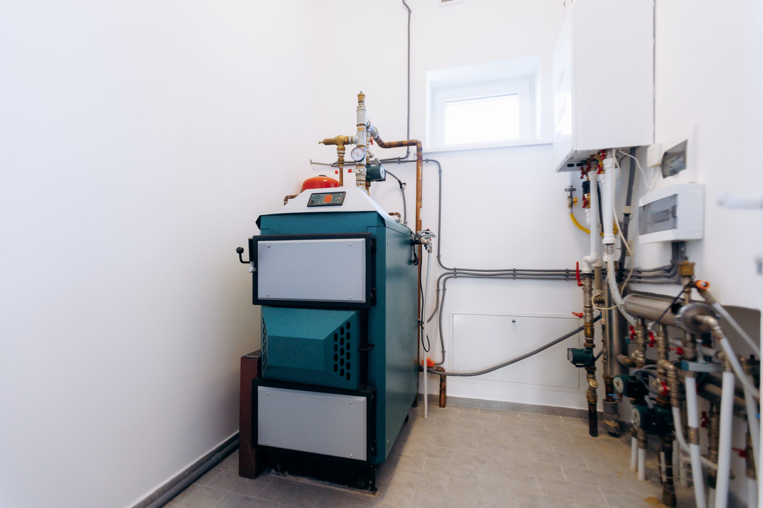 efficient boiler setup, hvac technician performing startup check on sleek boiler unit in utility
