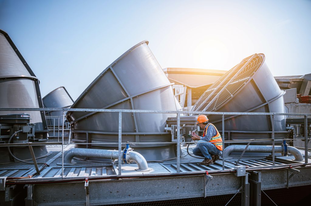 A engineer under checking the industry cooling tower air conditi